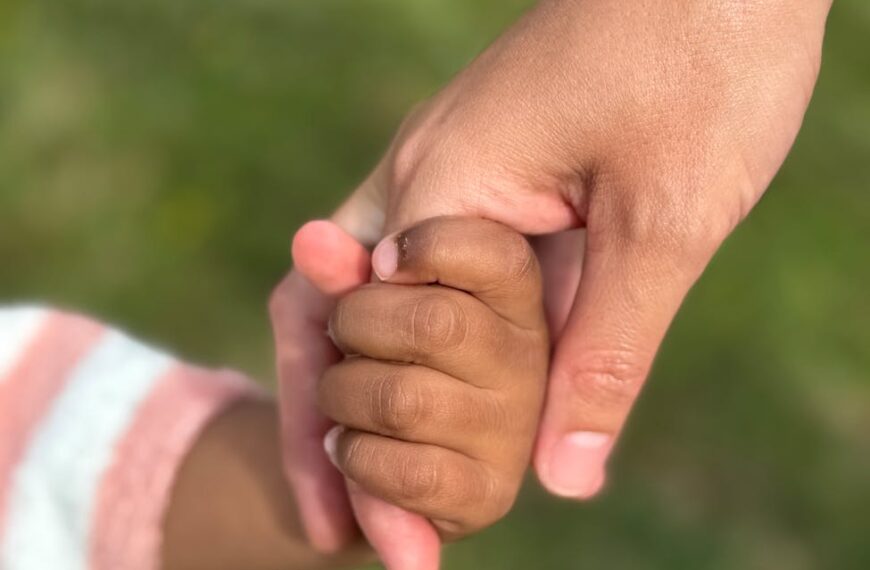 heartfelt moment of holding hands outdoors
